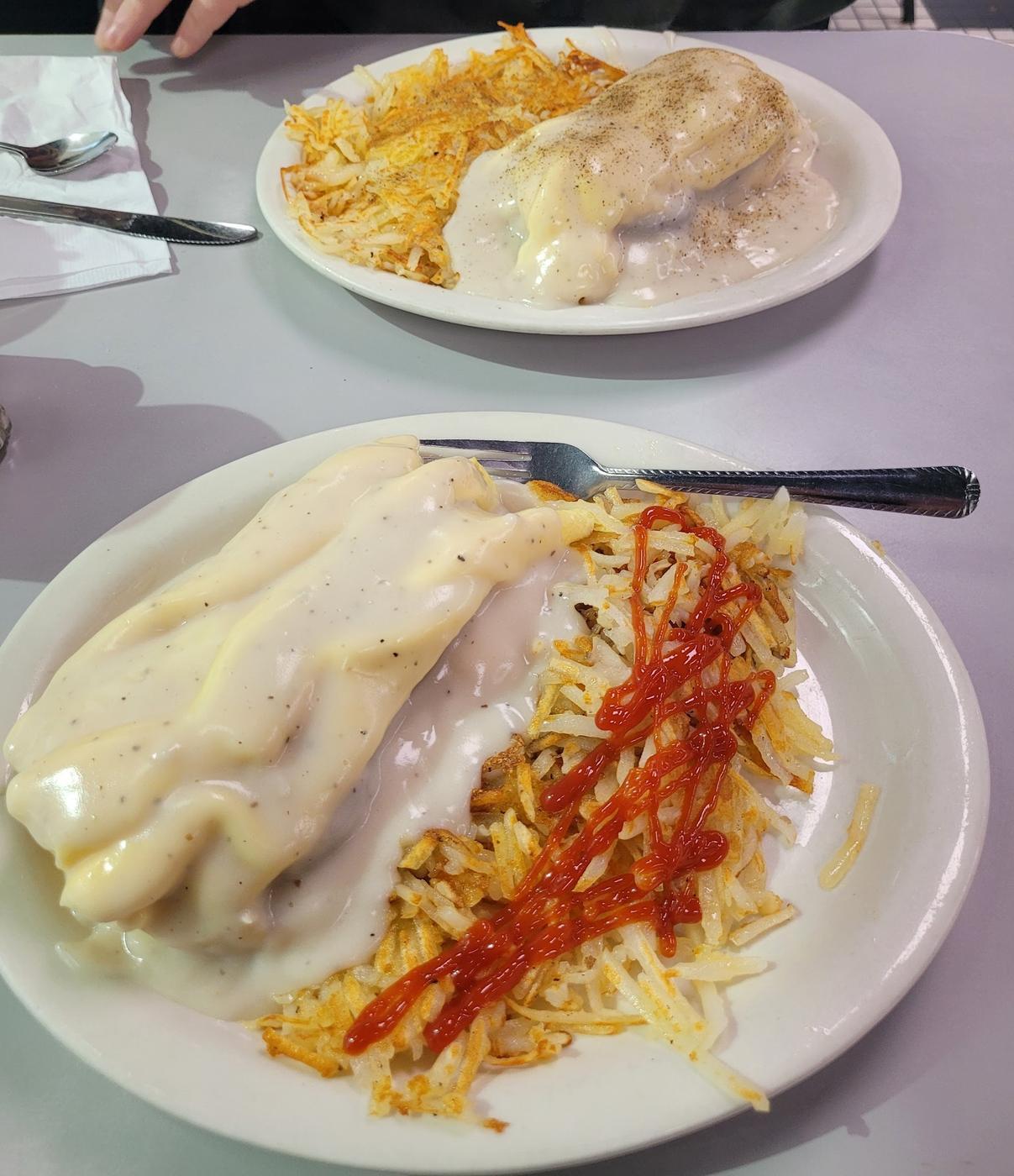 Biscuits and gravy served with hash browns
