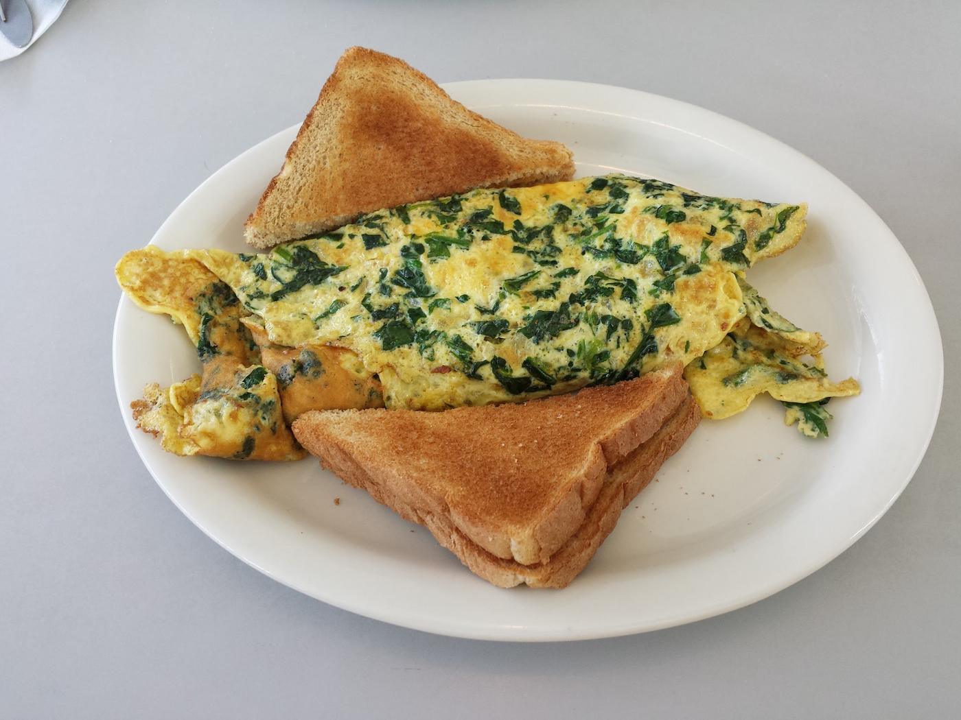 A spinach omelette with toast